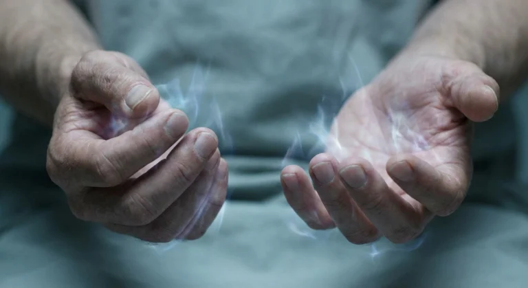 Close-up of mature hands with visual suggestion of tingling nerve sensation in fingertips