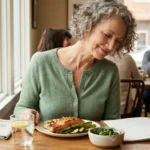 Woman with neuropathy confidently dining at restaurant with healthy anti-inflammatory meal choices